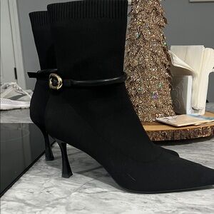 Chic Black Heeled Boots with Gold Accent